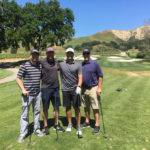 4 men on golf course